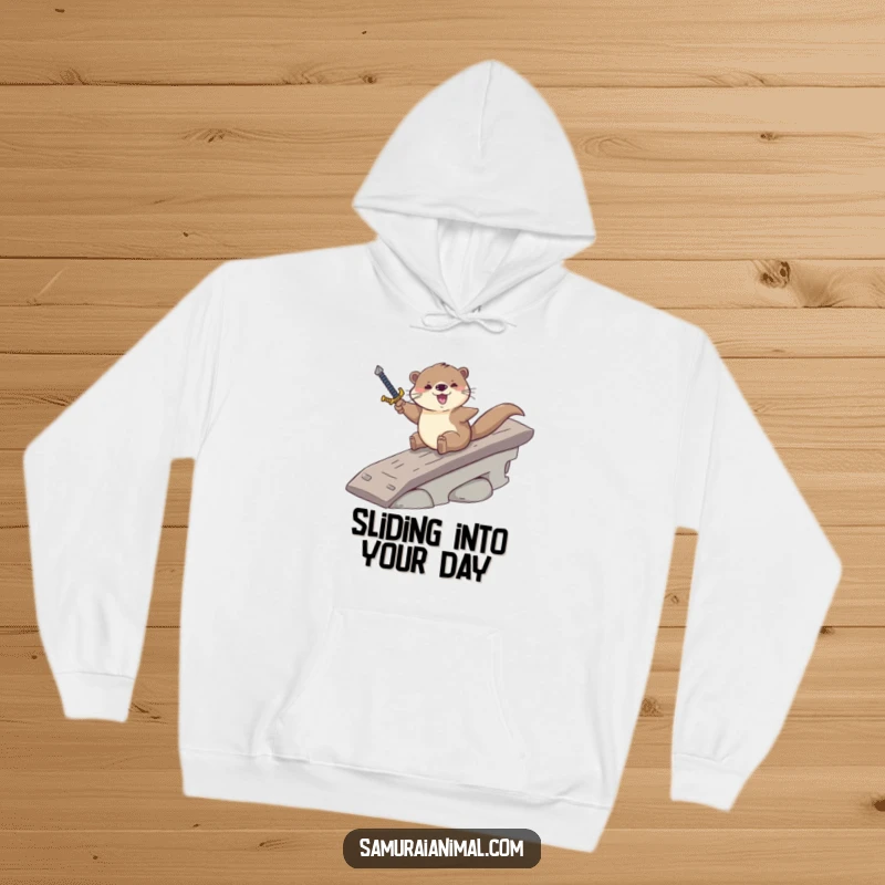 Funny hoodie showcasing a brave otter sliding down a ramp, gripping a sword, embodying courage and playful mischief.