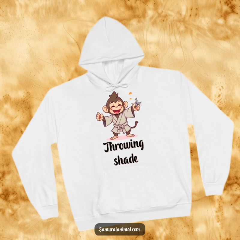 Funny monkey hoodie showing a cheerful monkey in a samurai gi, gleefully throwing a shuriken, ready for anything.