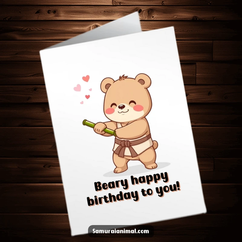 Cute free printable birthday card showing a happy bear swinging a bamboo stick like a sword, celebrating with a grin.